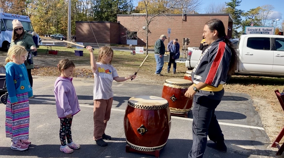 Kids playing taiko drums at a community event
